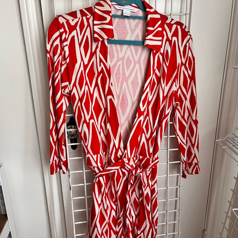 orange and white patterened DVF romper with long sleeves.
